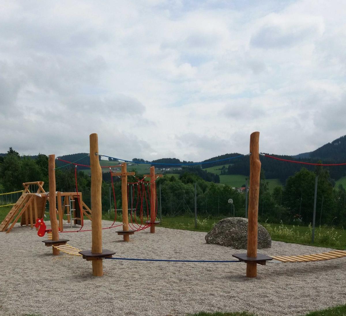 Spielplatz mit Holzgeräten und Kletterelementen